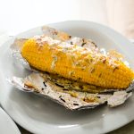 Ears of corn baked with herbs and cheese